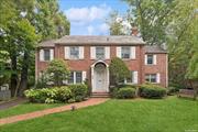 Introducing this elegant brick home, boasting 4 spacious bedrooms and 3.5 baths. The property seamlessly blends timeless architectural charm with modern amenities. Its open-concept design connects the den, living, and dining areas, complete with a cozy fireplace and a built-in library. The large eat-in kitchen leads out to a delightful backyard porch, perfect for outdoor relaxation. The first floor showcases brand-new hardwood flooring throughout, a convenient bedroom, a full bathroom, and a powder room. On the second floor, the expansive primary suite features two walk-in closets and a newly renovated en-suite bath, complemented by two additional bedrooms with ample closet space and a shared full bath. The finished basement offers exceptional versatility with an additional bonus room, a home office, a laundry room, ample storage, and a boiler room. The property also includes a generator powered by gas, a long driveway, and a one-car garage, providing both convenience and privacy. This home is a perfect blend of comfort, functionality, and classic appeal, ideal for modern living.