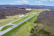 In the booming Hudson Valley at Sky Acres Airport (44N) is this rare aviation related opportunity in a fantastic setting. 14, 046 SF commercial space with two clear span hangars with space for 8 airplanes and other equipment. The second building, built in 2014, is a steel skinned advanced framing technique hangar with 1, 632 SF on one level. The paved parking lot has 25 spots. This all sits on 24+ acres of level and partially cleared land abutting the north end of the runway, with direct access to the taxiway from the hangars. Plenty of room to grow, with most of the land yet to be developed. Development potential of office, trade shop, light manufacturing, aviation schools and flight instruction, warehouse and a host of additional airport related uses. Access from a gated private road on the property, adjacent to Sky Acres airport, a full service airport with fueling station, terminal and restaurant, and approximately 40 miles to Stewart International Airport.