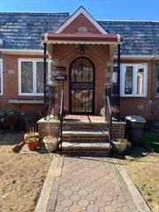 Beautiful brick one family Tudor home in Ozone Park&rsquo;s Tudor Village section. This charming home sits on a pretty tree lined street and is in walking distance to the train, buses, schools, restaurants and shopping. The first floor features an open floor plan with a large eat in kitchen, living room, dining area, two private bedrooms, new bathroom with a walk in shower, oak flooring throughout, two skylights and two new in wall A/C units. The lower level features a large eat in kitchen, full bathroom with a tub, large living area with an in wall A/C unit, laundry room with washer and dryer, back door that opens up to a private yard and one car garage. The furnace and hot water heater are only one year old. The cement work in the front was just completed 7 months ago.