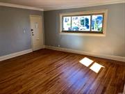 Beautifully renovated lovely first floor apartment. Gleaming hardwood floors and new eat-in-kitchen & bath. Coin operated laundry in the basement. Close to all major highways and transportation, buses, LIRR & restaurants. Deck in the front can be used with prior permission.