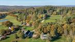 Welcome to a once-in-a-lifetime opportunity to own an exceptional equestrian estate sprawling over approximately 185 unrestricted acres in the heart of Millbrook hunt country. Originally built in 1865, this property has been meticulously expanded with a lavish addition spanning over 6000 sq ft, seamlessly blending antique charm with modern opulence. Enjoy miles of fenced pastures, riding trails, ponds, and panoramic views of the Catskill Mountains just minutes from the Village of Millbrook.Formerly owned by Margaret Carnegie, only child of Andrew Carnegie, this estate offers a piece of history and unmatched luxury. The main residence features a paneled library with fireplace, formal dining room with fireplace and a very generous living room with yet another fireplace and very high ceilings. Two staircases leading to separate wings and an elevator service both the primary suite and the finished basement.Designed by French architect, Atelier Choiseul, the exceptional stable boasts stables, paddocks, a tack room, lounge, and staff apartments. A hunter trial course adds to the recreational opportunities. Just minutes from Metro-North station, and a 90-minute commute to Manhattan, indulge in country living with access to prestigious activities like the Millbrook Hunt and Mashomack Polo.This rare offering provides unparalleled privacy, nestled in the serene countryside, yet with convenient access to urban amenities. Embrace luxury in the Hudson Valley&rsquo;s most coveted location. Additional Information: Amenities:Dressing Area, Guest Quarters, Marble Bath, Steam Shower, Storage, HeatingFuel:Oil Above Ground, ParkingFeatures:4+ Car Detached,
