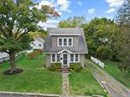 A vintage storybook house for modern living in a charming neighborhood just minutes from Warren Street. Inside are beautiful oak floors throughout and a living room with divided Craftsman knee walls and columns to nicely set off the dining room space. Sliders out to the back deck. Updated Kitchen features granite counters and stainless appliances including a new six burner gas stove. Up the gently curving staircase with vintage tread details, one finds a tastefully remodeled bathroom and three spacious and bright bedrooms. The Basement offers an additional 1/4 bath. New windows deliver lots of light throughout the house regardless of the time of day. Attic for additional storage.&#160;Fenced in back yard with mature plantings. Bordering next door is a wooded patch with a creek for privacy. Up the street is a public park for walking the dog, playing catch or for that morning run. Great neighborhood for biking too.Two car garage but ample street parking as well.