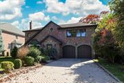 This timelessly elegant brick and stone center hall Colonial is perfect for the discerning suburban buyer who appreciates the charm and value of the Strathmore community in Manhasset, NY. The home features a soaring, light-filled entry that flows seamlessly into a spacious living room, dining room, gourmet kitchen, and den. Both the kitchen and den open graciously to a beautiful slate patio, complete with an outdoor kitchen, ensuring privacy and making it an ideal setting for holiday gatherings. The second floor boasts a generous primary bedroom with a luxurious spa bath and large closet. Three additional spacious bedrooms each offer private baths; one is en-suite, while another features a convenient Jack & Jill layout. The finished basement provides versatile space for the new owner to customize according to their needs. Additional highlights include Pella windows, a generator, a heated driveway, central vacuum system, and exquisite millwork throughout. This home is truly a gem waiting for its new owner