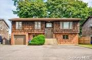 Welcome home to this charming hi-ranch in East Northport. Conveniently located close to all transportation, shops, parks, schools, and highways. This home boasts plenty of natural light, with 4 bedrooms and 3 full baths. Central Air upstairs is only 3 years old. Sliding glass doors lead out to a spacious, fenced backyard with brick walkways and a slate bbq area. The upstairs living area is open concept, with cathedral ceilings in the living and dining rooms. Hardwood floors under wall to wall carpet. Potential for an accessory apartment if owner occupied. A must see!