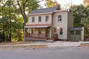 Welcome to this charming, fully renovated New England-style home, perfectly blending historic charm with modern comforts. Nestled on a spacious, private lot and surrounded by park land, you&rsquo;re under a 10-minute walk to both Ossining&rsquo;s train station and village center. Through the front porch, you are welcomed into a bright and airy living room with historic arch topped windows. The living room flows seamlessly into the spacious dining area, where three large windows frame lovely views of the backyard. The renovated eat-in kitchen is equipped with an induction cook-top, quartz countertops and high-end appliances. A door off the kitchen leads to a large back deck, perfect for outdoor dining or relaxation. Upstairs, the home features a spacious primary bedroom along with two additional well-sized bedrooms and a newly updated full bathroom. The walk-out lower level offers a rec room or home office, a laundry room, and abundant storage space, with potential for adding a new bathroom. The house is equipped with a brand new hot water heater and a high efficiency HVAC heating and central air conditioning systems. One of the standout features of this home is its expansive backyard, which is ideal for gardening, entertaining, or simply enjoying the fresh air. There is also a one-car attached garage with off street parking. Don&rsquo;t miss miss your chance to own this sweet home! Additional Information: ParkingFeatures:1 Car Attached, Appliances: Electric Water Heater