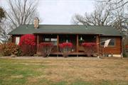 Come see this adorable 2 bedroom 2 bath Ranch style log home on 4.6 acres. This home has a lovely front porch that is inviting and space enough for your outdoor furniture to enjoy the fresh air and lovely views. Step inside to your cozy living room that has that relax and enjoy feel. The kitchen has beautiful solid wood cabinetry with an eat in space for your table set. Large formal dining area and cozy living room. Rite off the kitchen is a huge screened in room for chilly or warm evenings to have a meal or enjoy the lovely views of the property. Primary bedroom is very spacious and the primary bath boasts a slipper tub for relaxing soaks. the second bedroom is lovely and is set at the other end of the ranch. There is another full bath. Full unfinished basement with B-Dry system. All kitchen appliances included, washer and dryer in basement. Large detached garage for car storage. Beautiful large back yard for your gardening dreams.