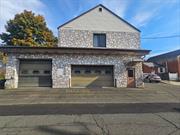 This versatile two-story masonry and wood-frame building, formerly the Stony Point Ambulance Corps, is in excellent condition and ready for various uses. The first floor features a spacious garage with drive-in truck bays and overhead doors, ideal for contractors, service businesses, or storage. The second floor offers an open area suited for offices, conference rooms, or workspaces, complete with a kitchenette and bathrooms. The fully paved lot accommodates nine cars, making it convenient for clients and staff. Currently zoned for office use, other uses would require a zoning variance. This property combines functionality and flexibility with ample parking and thoughtful design perfect for your business or investment needs.