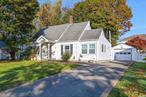 Sunny and bright cape on quiet dead end street in Carle Place School District. There is a living room, with built-ins, a formal dining room, updated eat-in kitchen with tile floors, loads of granite counters, glass cabinet door accents, tile backsplash and cathedral ceiling. Additionally on the main floor are two bedrooms and an updated tiled bath. Upstairs are two additional bedrooms and another beautiful full bath. Great features include, ductless AC units, built-ins, updated baths, pantry storage, washer & dryer, covered patio, fenced yard with sprinkler system, vinyl siding, 1-car detached garage. Nice neighborhood location, yet close to all central Nassau has to offer including shopping, dining, entertainment, fabulous parks & recreation, LIRR, major parkways and a half hour to Long Island&rsquo;s famous South Shore beaches.