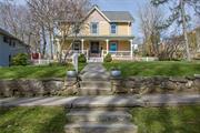 Delightful C1900 Farmhouse Colonial located on the prettiest streets in the Village. Updated, renovated, & designed to perfection. There are period wood flrs, an updated airy kitchen w/quartz counters, open to a country dining area w/sunny bay window & back dr to patio. The large LR runs front to back w/deep windows, lots of light & sliders to the patio. The covered front porch w/vintage millwork adds to the character of this home & it&rsquo;s perfect spot to watch the world go by! Upstairs 3 bright BR&rsquo;s & a luxurious, spacious bathroom w/marble topped custom vanity, double sinks & restored wide plank flrs. The walk up attic is finished storage (not incl. in sq. ft.) w/custom built ins, carpet & skylight, perfect for today&rsquo;s work/life needs, including high-speed network & TV. Outside, a large paver patio, ideal entertaining space, complete w/tiered, landscaped gardens, fully fenced, a chicken coop, 2 storage sheds & playhouse. Come home to this country oasis in the most convenient location! Additional Information: HeatingFuel:Oil Above Ground,