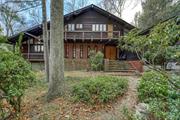 This one-of-a-kind mid-century modern gem, designed by architect Murray Blatt for his own family, is a true architectural treasure. Filled with custom details, it boasts skylights, updated flooring, exotic wood finishes, and striking built-ins. The sunken living room features an original built-in sofa and a double-sided fireplace shared with the formal dining room. A spacious first floor bedroom with en suite bath, a sunny rec room, and a large newly renovated eat-in kitchen boasting stainless steel appliances and marble countertops that complete the first floor. Upstairs, a light-filled landing leads to four bedrooms and a full bath. The home sits on just under an acre of lush, mature landscaping with multiple decks for outdoor enjoyment. Located under an hour from NYC, this extraordinary home offers both privacy and convenience.