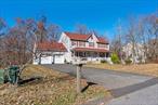 Spacious four-bedroom Colonial in desirable Fostertown Crossing, a well-maintained, attractive development in the Town of Newburgh, central to shopping, local transportation, highways and commuter routes.  Nicely flowing floor plan with a large kitchen open to the family room, light and bright with a cozy woodburning fireplace. Eat-in kitchen area with sliders to the freshly painted deck overlooking a level back yard. Formal dining and living rooms, and a convenient powder room on the first floor. Master bedroom suite with soaking tub and walk-in closet. Additional full bathroom with dual sinks. Full, finished, legal walk-out basement adds welcome extra space. A charming lemonade porch, overlooking the quiet, pretty street, runs the length of the house. 7-year old roof, newer garage doors and large level back yard. Neat, well-cared for neighborhood with trouble-free municipal water and sewer services. Close, easy access to I-84 and I-87 and a few minutes drive to Stewart International airport, Metro North and bus service to the Port Authority in NYC.