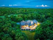 This timeless, Colorado lodge-style home is extraordinarily built and centered on 75+ acres in the heart of Millbrook. Located on one of Millbrook&rsquo;s country roads, close to the village. A gated entrance leads to this unique, 11, 500 square foot home constructed of standing dead timber from the west and immense stone from Pennsylvania. The colossal logs, which measure up to 41 inches in diameter, were cut and laid in place out west before being deconstructed and transported to its current location. The open floorplan lends itself to grand entertaining while offering enough niche areas to cozy-up in. At its center is a dramatic great room featuring a vaulted 32-foot ceiling and a mammoth fireplace that one can stand-up in. The wonderful chef&rsquo;s kitchen and adjacent full-size pub, den with fireplace and chess room add to the unique entertaining ambiance. There are five bedrooms suites which all open to their own private, covered porches. There are four full bathrooms plus three additional powder rooms. The kitchen boasts soapstone countertops and two sinks; and the 34&rsquo; x 17&rsquo; formal dining room can accommodate dinner parties for 30 people. Extending the space outdoors is a 2, 700 square foot deck with a huge outdoor stone fireplace and hot tub, all which can be accessed by most rooms on the first floor. The lower level features a game room with stone fireplace, an office with stunning mahogany built-ins, a soundproofed music room/recording studio, a professional soundproofed indoor shooting range, a mudroom, and a four-car tandem garage. Built in 2007, nothing was spared in the design and craftsmanship of this home including the 60 KW generator, built-in elevator shaft for a possible future addition, ventilation system in the lower level for enjoying an after-dinner cigar. The mechanicals are top-notch and include radiant heat throughout with 6 zones, Vantage lighting and alarm system, and a Creston sound system. This property also includes a barn and three ancillary residences perfect for overflow of guests, rental properties, or a caretaker. This is a rare opportunity to own the most unique property on the Millbrook market - perfect for the consummate sportsman or anyone who loves to entertain. Additional Information: Amenities:Guest Quarters, ParkingFeatures:4+ Car Attached,