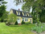 Idyllic Quogue South Rental -This bright, fully-renovated farmhouse in the heart of Quogue sits adjacent to 14 acres of private woodlands. The main floor features a newly-renovated first-floor primary suite, living room with wood-burning fireplace, cozy sunroom/study, and kitchen with a sunny dining area. Upstairs are three more bedrooms and an updated bath with walk-in shower. On summer evenings sit outside and enjoy the shady patio dining area, heated pool, and surrounding woods and gardens. Less than 1 mile from the Quogue Bridge/Dune Road, only 1.7 miles from the Quogue Village Beach, and barely 3 blocks from shops and Hampton Jitney. Available July 1-15 only.