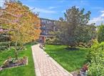 BACK ON THE MARKET...Ground level one bedroom with yard/patio access. Enjoy the warmth and elegance of newly sanded and varnished hardwood floors. Professionally managed with an inground pool, indoor and outdoor parking. Maintenance fees Include taxes, heat, gas, trash removal and landscaping. Conveniently located near LIRR, shopping, restaurants, and beaches.