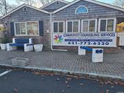 Commercial building on Neighborhood road presently the Community Counseling Center. This buiding has been completely renovated over the last 3 years and offers 12 offices/rooms, 2 Bathrooms, Kitchen and a waiting area. There is a good size parking lot for approximately 2o cars. There is also a basement rec room and extra rooms for storage as well a back yard and separate detached huge finished shed with AC. Comes with additional lot next to side parking lot.