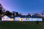 This Architect designed mid-century modern home on one of Rhinebeck&rsquo;s prettiest roads has been completely and expertly renovated with meticulous care for detail and top of the line furnishings. Inside this sun lit home you will find a well laid out floor plan featuring large rooms with multiple communal spaces, and large windows with pastoral views.Enter the home via the spacious front entry equipped with a large convenient coat closet, or enter via the spacious mudroom connecting the large two car garage and the kitchen. The house features a great room, with fireplace, skylights, and a cathedral ceiling creating the ultimate entertainment room with space for living, dining and a piano. It feels open, and bright with large windows, and a wall of glass overlooking the expansive private backyard suitable for a swimming pool.The brand new, thoughtfully designed gourmet kitchen has a brand new top of the line Liebher refrigerator, a Bosch Dishwasher, a Bertazzoni 5 burner induction range with exhaust, oversized windows on two walls, and abundant counter space. A third wall with extra deep counters was designed for small appliances and a coffee station, or an excellent place for a buffet. There is a cozy family room positioned between the kitchen and great room, which is ideal for curling up with a book or watching TV. Down the beautifully curved hallway, is the primary bedroom with luxurious, spa-like ensuite bathroom, with double vanity, ample cabinets, white subway tiles, windows, and an oversized glass enclosed shower. There are two additional guest bedrooms and a full bath with a deep soaking tub. The attached accessory apartment (a legal second dwelling), which would also make an excellent home office, features a sitting room, kitchenette, full bathroom, and a loft with bedroom and sitting area. It has the versatility of two entries: one connecting to the main residence via the mudroom and another private door on the rear of the house. The expansive lower level has a laundry room (there is an alternative laundry area on the main floor next to the kitchen and half bath) and plenty of room for finishing and storage. In addition to the two car garage, there is space for several cars in the horseshoe driveway.This home is close to everything the Hudson Valley has to offer: 7 minutes to the vibrant Village of Rhinebeck with farmers markets, shops, restaurants, spas, Upstate Films, Rhinebeck schools and community events. It is 10 minutes to Amtrak in Rhinecliff (1 hour 40 min to Penn Station), 22 minutes to Metro North in Poughkeepsie, or the Stockade District in Kingston, 1 hour 40 minutes drive to the GWB.