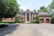 Located in Woodsburgh, Long Island, this stunning brick colonial home, built in 2001 on 1.09 acres, offers luxury living in the 5 Towns. Featuring 8 bedrooms, 9 full and 3 half baths, a private guest entrance, and two laundry rooms, the home is designed for elegance and convenience. An elevator connects all four floors, including a finished basement with an 8â€™ ceiling, party room, catering kitchen, theater, playroom, fitness room, sauna, steam room, and indoor endless pool. Vaulted ceilings, custom lighting, marble radiant heated floors, and exquisite millwork enhance the sophisticated ambiance. The chef&rsquo;s kitchen boasts double major appliances, while patios off the living room, family room, kitchen, and master suite extend the entertaining space. Outdoors, enjoy an in-ground heated pool, hot tub, water slide, diving board, built-in barbecue, lounging areas, and a sports court. Two attached 2-car garages complete this exceptional home, ideal for entertaining and luxury living.