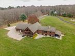 This picturesque custom home underwent an extensive renovation and expansion. The property features a main house and custom barn/heated workshop. Upon entering, you&rsquo;re immediately welcomed into a grand, two-story great-room that seamlessly connects to a spacious chef&rsquo;s kitchen. The kitchen boasts handcrafted cabinetry, a soapstone farm sink and countertops, stunning vaulted ceilings and high-end commercial-grade appliances. The barn trusses, wide plank oak floors, and a brick fireplace enhance the rustic elegance of the home. Off the kitchen is a sliding 12 ft. glass door that opens to a covered/enclosed 3-season sunporch with an outdoor living and kitchen area. The west wing of the house accommodates two bedrooms, including a first-floor Primary suite with a wood-burning fireplace, a large walk-in closet, and a full bath. A second bedroom and a full bath/laundry room area complete this wing. Large bonus room/bedroom, currently being used as an office, is conveniently located on your second level. Enjoy heated floors in your lower level offering a partially finished family room and an additional bedroom space with full bath. The property is well-equipped for every season with 3 fireplaces, a 3-bay heated garage, newer central air system, roof, windows, and a built-in generator. Whether you&rsquo;re a horse enthusiast, a hobby farmer, or a culinary connoisseur, this property invites you to embrace the joys of country living in the Litchfield Hills. Agent/Owner related.