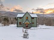 Set on a sunny knoll in prime Catskills ski country, Rusk Mountain House offers historic charm and modern amenities - plus 3 picturesque acres, with private creek access and epic mountain vistas. Lovingly hand-restored by its current owners, the nearly 2000sf antique farmhouse offers a flexible floor plan, easily accommodating versatile uses - from daily living, to working, creating, and entertaining. The highlight of the main level is a large, bright kitchen that opens into a sunny sitting room, with wood burning fireplace and glass sliders that lead out to the rear yard. These adjoining rooms enjoy stunning views of the mountain landscape, and a scenic meadow path that meanders through the rear acreage down to the creek.The custom kitchen houses an oversized island with storage, seating, and plenty of prep surface. It also features stainless steel appliances, including a dishwasher, 6-burner stove, and vent hood. Beyond the kitchen is a mud room with laundry, and side entry. This area has built-in ski racks, and plenty of storage for boots and other winter accessories. And also includes access to the first floor bathroom, with an original clawfoot tub - perfect for apr&#195;&#169;s ski soaks. The main level also features a welcoming front entry, open-flow dining area with bay window, and cozy den with built-in bar - all with gleaming original wood floors. Up the central stairwell, with classic curved wood banister, are four bedrooms and another full bath. This second full bathroom has a tiled walk-in shower with glass enclosure, and built-in shelving for storage. The upper level also features wood floors throughout, and access to a walk-up attic.This modern mountain homestead received many updates over the past 4 years - including spray foam insulation, Hardie plank siding, an EV charger, and double-pane windows and doors throughout. The sellers also made many improvements outside the home, like planting fruit trees & berry bushes, creating a kids playscape with geodesic jungle gym/hammock, and shoring up the old barn to preserve it for a future owners imagination.Rusk Mountain House offers the upstate trifecta of character, views, and location. Just a 4 min drive from shopping, dining, and more in the village of Hunter - and of course, the popular ski destination, with a summit elevation of 3, 200 ft. Come see this ideal mix of classic charm and modern convenience for yourself, at the Open House this weekend: Sat, 12/7, 11am-2pm!