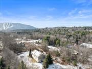 Tucked away on a secluded dead-end road just minutes from town, this beautifully maintained 2, 800 sq. ft. contemporary home offers stunning south-facing views of Windham Mountain. This spacious retreat promises effortless enjoyment in every season.Enter through a spacious mudroom with 9-foot ceilings, thoughtfully enclosed by French pocket doors. Upstairs, a sun-drenched open-concept living area adjoins a peninsula kitchen featuring stainless steel appliances and a wine fridge. Two sets of sliding doors provide breathtaking views of Windham Mountain and effortless access to the sunny, expansive deck.The lower level boasts two charming bedrooms, a second large family room with sliding doors to the patio, and a hot tub. Outside, the home is artfully framed by mature plantings and enhanced with recent hardscaping, including a bespoke masonry fire pit surrounded by Adirondack chairs.This well-insulated home also features a Buderus boiler, mini-splits, and a WaterCop system, offering peace of mind during extended absences.Located just 5 minutes from Windham, 20 minutes from Hunter, and close to the best outdoor recreation and dining in the Catskills, this bright and welcoming home is move-in ready, combining privacy, sunlight, and stunning views. Offered furnished.