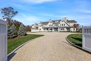 This stunning waterfront home in Quogue offers direct access to Shinnecock Bay via a private boardwalk. The property features a minimal-maintenance exterior, expansive outdoor living spaces with a full kitchen, BBQ, pizza oven, and bar, plus a heated saltwater infinity pool and oversized hot tub. Inside, a grand foyer leads to a custom wine room, while the primary suite includes a fireplace, wet bar, two balconies, and luxurious en-suite with steam shower and tub. The home offers seven bedrooms with en-suite bathrooms, two bonus rooms with wet bars, a spacious great room, a sauna, and a private movie theater. Additional highlights include a chef&rsquo;s kitchen with double islands, top-tier appliances, and a screened-in porch with motorized windows. Enjoy panoramic water views, custom oak flooring, Lutron lighting, and high-end finishes throughout. This new construction home, designed by Summerhouse Builders, offers an unparalleled living experience.