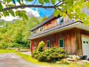 Barn-Style contemporary home on Rocky Mountain Way has much to offer, beginning with access to beautiful Whaley Lake, from where residents can enjoy boating, fishing, kayaking, more! The property is surrounded by 200+ acres of protected land. Well-built home offers an open concept design and lots of windows which fill the home with natural light. Open to the great room, the kitchen offers brand-new quartz counter tops, large gas range, stainless appliances and door to huge deck with lighting. The great room is very spacious, as is the open dining room. Primary bedroom offers French doors which open to large deck with hot tub. The primary has access to a full bathroom with a step-in shower and seat. Laundry as well. Central air, heated floors throughout - including the 2 car Garage! Nature lovers will be so pleased with the easy access to hiking the Appalachian Trail or the surrounding trails as well! of construction includes Andersen Windows, Steel I-Beams, Poured Foundation, Metal Studs.