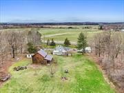 Whether you&rsquo;re an investor looking for a profitable opportunity or a remote worker seeking a peaceful home with ample outdoor space, this charming farmhouse ticks all the boxes.Step into a piece of history with this beautifully updated 1780s farmhouse, where the charm of country living meets the conveniences of modern life. Picture yourself enjoying breathtaking panoramic views of the Catskill Mountains and mesmerizing sunsets from the comfort of your own home. This property not only offers a serene retreat but also presents lucrative income potential.With 3 bedrooms and 2 full bathrooms, this farmhouse features multiple living areas, including a versatile room that can easily transform into a third bedroom or guest roomâ€”perfect for family gatherings or entertaining guests. Stay warm with the inviting fireplace or cozy up by the wood stove in the living room. The expansive eat-in kitchen is a chefâ€™s dream, equipped with generous counter space and ample cabinetry, giving you the room to create culinary masterpieces. The separate laundry room adds convenience to everyday living. Experience the great outdoors with three distinct spacesâ€”relax on the balcony off the primary ensuite bedroom, picnic on the side patio, or unwind on the full front porch, facing the expansive mountain views. Each space is designed for enjoyment and connection with nature.This property is ready for you to move in, with significant upgrades already completed. Enjoy peace of mind with a new propane boiler, an on-demand hot water heater, a state-of-the-art water treatment system, structural reinforcements, and an upgraded septic system. All thatâ€™s left is for you to choose your paint colors and personalize your space!The one-bedroom apartment adjacent to the detached garage offers additional living space or rental income. Recently upgraded with luxury vinyl plank flooring, new appliances, and updated kitchen and bathroom cabinetry, itâ€™s perfect for tenants seeking comfort and style.Explore the additional features that make this property truly unique: off-street parking, a work/tool shed, and a spacious 32&rsquo; x 20&rsquo; barn that could serve as a workshop, art studio, or hobby farm storage. The charming bunkhouse awaits your creative vision!Donâ€™t miss out on this rare gem! Schedule a showing today and envision the endless possibilities that await you in this picturesque setting.