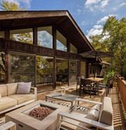 Situated on 7 acres of rolling hills and meadows, this renovated mid-century home offers privacy in a bucolic setting. The sizable entry foyer is brightened by a skylight and built-in bench. The main living room incorporates vaulted ceilings, exposed beams, a large wood-burning fireplace, and sliding doors to access the generous deck with unobstructed views. The formal dining room leads to a kitchen with stainless steel appliances and an exterior door to the pool area. Three bedrooms on the main floor include a primary suite with walk-in closet and full bathroom, two guest rooms, and a second full bathroom. The lower level offers an additional living room with fireplace, third full bathroom, two more bonus rooms, and a laundry room with storage and access to the 2-car attached garage. Outside, you will find an in-ground heated pool, a wood-burning fire pit overlooking the back meadow, and a pond shared with the adjacent property. Established short-term rental. A serene escape, yet just minutes to the Taconic State Parkway. 20 minutes to villages of Rhinebeck and Millbrook.