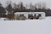 5 ACRES outside Walton, NY is home to this spacious double-wide which has so much to offer! Open floor plan, loaded with charm: 4 bedrooms, two full baths, all set well back on a country road just 6 miles to WALTON. One-level living that boasts an oversized living room which is open to the dining room and has lots of bright natural light and easy access to the kitchen with generous cabinets, newer appliances, a breakfast bar and separate eating area. There are 4 nice sized bedrooms but the primary is HUGE and boasts not only two large closets but, an ensuite where the full bath has both a shower and separate oval shaped tub. The front porch is perfect for relaxing and has great long-range mountain views. Level 5-acre lot surrounded by large agricultural farms. Abundant lawn area and lots of space for your gardens, a firepit, playground or new deck. 10x20 shed for gardening tools. Hi-speed internet available. Full size washer (new) & dryer. Easy commute to town for shopping, schools, highway access, restaurants and more.