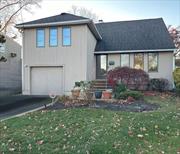 Welcome to this expanded split level home ! This home features hardwood floors throughout (in bedrooms as well), Anderson windows and doors, high hats, and crown molding. The kitchen is newly renovated featuring granite countertops and stainless steel appliances. Gas cooking for your convenience! The second level has two large bedrooms (hardwoods underneath the carpet) and a full bathroom. Third bedroom is located on the highest level, begging to be turned into your primary suite ! There is an additional bedroom on the ground level with an outside entrance. The home is also equipped with electric car charging port and in ground sprinkler system. The backyard is fully fenced with a large shed and is completely usable! Located just off of Merrick road with easy access to all shops and convenience. Call today for interior photos and more information on this beautiful property!