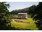 Ingadi, the Zulu word for garden, is a true legacy compound all set within 127 acres of pristine land with a total of 11 bedrooms across four distinct residential structures. A magical journey of the senses where the Roeliff Jansen Kill and the Shekomeko Creek merge, ensuring sustainability while creating one of the most spiritually powerful and visually stunning experiences in the Hudson Valley. Rich in wildlife with numerous farming components already established there is tremendous opportunity for expansion. The recently completed 7, 500sf main residence features lime stucco walls and solid fieldstone masonry on the interior and exterior with a mix of hardwood and Jerusalem limestone flooring. With 4 en-suite bedrooms, the residence also includes a powder room, a private study, large laundry room, wine cellar, and a yoga studio. The living room with 26â€™ ceilings is bracketed by two fireplaces. While embracing traditional craftsmanship and materials, the house is equipped with every modern convenience including an infrared sauna, steam room, 3 fireplaces, motorized shades, insect screens and radiant heated floors. The terrace has a covered seating area with a fully equipped kitchen, radiant floor heating and overhead heaters. The open design kitchen features a large pantry and workspace, 3 thick limestone counters, solid 3 walnut island with AGA stove and bar cabinet, twin dishwashers and sinks, crisper drawers, fridge, freezer, and wine fridge. There is a dog wash, covered firewood storage and a climate controlled two-car garage. South of the house, with magical river views and a fieldstone patio, sits a 60ft heated pool with an auto-cover. There is also an outdoor shower. A renovated cottage delivers two separate living spaces: upstairs is a 3-bedroom cottage and downstairs is a 2-bedroom apartment. Several barns date from the 1700â€™s to the early 1900â€™s including an equestrian barn with 9 large stalls plus 6 outdoor summer stalls, heated wash stalls, tack room, office and feed room with a renovated 2 bedroom apartment above. There is an outdoor ring with show quality footing. Years of extensive effort has restored this sacred piece of land that inspires walking barefoot through the forest, basking in the river bends, and taking wild weed walks through the abundant forests that comprise a large portion of the property. Multiple outdoor living room vignettes with wooden decks inspire glamping and play in the natural beauty of this truly divine land. For sports enthusiasts; riding, hiking, biking, rafting, kayaking, and superb fly-fishing are in abundance. Located 5 minutes from Pine Plains, 25 minutes to Rhinebeck and Hudson. This rare offering epitomizes the Hudson Valley dream.