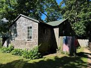 Mastic Beach cottage with 2 bedrooms 1 bath in need of renovation. Situated on a nicely wooded lot with detached garage building. This home has great potential. Cash buyer needed.