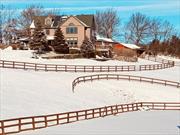 Welcome to Dream Mountain Ranch, Where Eagles Soar and Horses Play. Perched atop a mountain at the top of Eagle Crest Road, this breathtaking contemporary colonial home and horse ranch offers panoramic views of the Hudson Valley. Set on over five acres, the property features multiple stone patios, three horse paddocks, a large outdoor riding arena, and a four-stall barn equipped with a heated tack room, wash stall, and ample storage. The barnâ€™s layout allows for easy conversion into two additional stalls, catering to equestrian enthusiasts. Step through the front door into a grand foyer with soaring ceilings and gleaming hardwood floors that set the stage for elegant country living. The chefâ€™s kitchen is a culinary dream, boasting granite countertops, a six-burner gas stove with an expansive range hood, and plenty of space for meal preparation and entertaining. The living roomâ€™s floor-to-ceiling windows flood the space with natural light while framing the stunning landscape. Step out onto the massive life-proof deck to fully immerse yourself in the serene surroundings. Ascend the sweeping staircase to the second floor, where architectural magnificence continues. Overlooking the living room below, the second-floor landing offers more opportunities to soak in the extraordinary views. The luxurious primary suite features its own private balcony, a spacious walk-in closet, a cozy fireplace, and a spa-like en-suite bathroom with a walk-in shower, a soaking tub, dual vanities, and heated floors for ultimate comfort. The second floor has two additional generously sized bedrooms with ample closet space, a second full bathroom, and a convenient laundry room. The finished walk-out basement adds 910 sq. ft. of versatile living space, bringing the total to 4, 117 sq. ft. This lower level opens onto a stone patio overlooking the paddocks and picturesque countryside. Additional features include a two-car garage and a mudroom designed for practicality and convenience. Whether youâ€™re seeking a forever home or a serene country retreat, Dream Mountain Ranch is truly one of a kind. Located just 15 minutes from Garnet Medical Center and less than two hours from New York City. This extraordinary property offers an unmatched blend of luxury, functionality, and natural beauty.