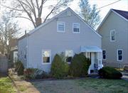 LOW TAXES! Welcome to this adorable Cape Cod-style home, having the perfect blend of comfort and functionality for those looking to simplify their lifestyle. The main floor features a primary bedroom with a private bathroom and easy access to a laundry area. Upstairs, two additional bedrooms provide cozy living spaces, with plenty of closets and big storage space. Updated kitchen with casual dining space, a formal entertaining dining room, and stunning hardwood floors throughout. Modern recessed lighting, a refreshed full bathroom, and thoughtful updates add to the homeâ€™s appeal. Outside, the backyard is ready for gatherings with a covered patio and a handy storage shed. The front door with elegant leaded glass and keyless entry completes this homeâ€™s charming curb appeal. Conveniently located near Valley Stream and Gibson LIRR train stations, this bright and welcoming home.