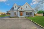 Jamesport-Welcome home. Move right in to this wonderful home-custom built in 2018.  Open sun-filled floor plan-Living room with stone (river rock) fireplace and wood storage, open dining area and kitchen. The kitchen is a chef&rsquo;s dream-lots of cabinetry, quartz countertops, stainless steel applicances, and a kegerator (refrigerator and tap) built in. Custom flooring from Germany throughout home. Laundry/mud room with a pet wash shower and powder room. The door to mud room leads to yard with 20x30 patio, Jacuzzi hot tub and built in wood burning fire pit and bucolic views of farmland. A perfect North Fork getaway or primary home close to the best beaches, wineries, restaurants, and shopping.