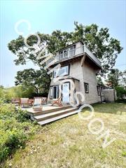 A spectacular location and a unique lighthouse style home sitting on just under a half acre, with 3 levels overlooking Shinnecock Bay in the premier bay-front community of East Quogue. Offering exquisite water views from both inside and out, with a ground floor deck, sliding doors to the dining room and kitchen and a wrap-around upper deck complete with breath taking panoramic views from the 3rd floor great room. 2 bedrooms and 2 full bathrooms total, including a spacious primary suite with walk-in closet, a generously sized living room with fireplace for entertaining, and an open kitchen/dining room concept. Includes a large 2 car detached garage with permits in place to extend/attach to the main house. The perfect waterfront getaway during any season.