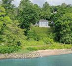 Moon River is an extraordinary Hudson Riverfront home in the iconic Snedens Landing neighborhood of Palisades, NY - star of the Lower Hudson Valley (search WSJ, NYT, Forbes) and only 25 minutes from NYC. It&rsquo;s snuggled on the Hudson shoreline below and inspired by the cliffs of Palisades that surround it, providing this early 20th century home an extraordinary line of sight/view of the Lower Hudson Valley & river for miles. The property is 1.4 acres and situated in a wooded environment. Moon River is approximately 4, 300sf, with 5 bedrooms and 5 full and 2 half baths, including 2 primary bedroom suites, each with a fireplace. Additional architectural features include very old wide board wood panels used in the ceiling and walls of the great room, along with massive/antique ceiling beams too. Two of the four fireplaces offer very deep/big fireboxes, ideal for building big fires. The home&rsquo;s stairwell features thick, solid cedar stair treads, carved from trees that grew in the area, and old-style balustrades at the top landing, possibly from an old monastery in Europe. There is also an oversized 2 car garage with lots of storage, an inground, heated pool with a gazebo and a small colonnade, overlooking the Hudson River. Moon River is an architectural home that feels more like a villa than a house, because of the privacy it offers and it&rsquo;s perfectly situated in the landscape, overlooking the water. It was built by legendary artist/resident, Mary Lawrence Tonetti, and designed by renowned architect, Eric Gugler, commissioned in America and Europe, and commissioned by FDR to redesign the oval office in the 1930s. At this same time Gugler designed Moon River he worked in the White House. He was friendly with architects McKim, Meade and White, in their day. Charles McKim was a friend & frequent visitor to Snedens, where Eric Gugler also had a home. When M.M.W. shut its doors on Fifth Ave in NYC, Gugler salvaged the original staircase from their office and used it in another property in Snedens Landing. The property is located in a historic district that dates back before the Revolutionary War to the late 1600s and adjoins about 3, 000 acres of state parkland. Tallman State Park is on the north end, Lamont Observatory, part of Columbia University, which adjoins Palisades Interstate Park property, on the south end and the Hudson River is to the east. There is no through traffic in the community because there is only one road in and out in this neighborhood of about 100 homes. This is the magic of living in Snedens Landing. There is next to no car traffic, which makes it the perfect place to walk for miles. Moon River offers a luxury waterfront lifestyle, rich with provenance and is situated in a park like setting. It was built for the Lowndes family. Moon River signifies the first night there&rsquo;s a full moon on the Hudson, after the forsythia bloom in early spring, where according to legend, the shad fish run plentiful in the Hudson, and fisherman would set their nets, supported by long poles, in the river to catch them. This tradition was practiced at this property for many years. Snedens Landing is a 5-minute drive, or 35-minute walk thru Tallman Park, to the historic Hudson Riverfront village of Piermont, which offers many excellent restaurants, shops marinas and more. It also has a tennis association open to residents only for a nominal fee. Find your one of one. Discover Moon River!