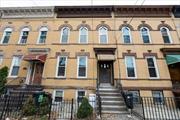 Beautifully renovated this Renaissance revival row house, blending modern updates with classic charm. Located in a sought-after neighborhood, this home features a spacious open-concept living area with gleaming floors, large windows that fill the space with natural light and stylish finishes throughout. Restored brick facade adorns living space. Open concept living with Kitchen Dining & Family room. MASSIVE space. 3 generously sized bedrooms. Renovated Bath.This home offers the comfort of modern living while retaining the character and charm of its historic roots. Conveniently located near shops, dining, public transit, and parks, this move-in-ready apartment is a rare find.