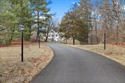 Discover timeless elegance and modern comfort in this 3-bedroom, 3-bathroom colonial-style gem, perfectly situated on a private, park-liKe 1.26 acres in the coveted Putnam Valley community. This home is a true masterpiece, blending timeless charm with contemporary amenities. From the moment you approach, the inviting front deck welcomes you into a beautifully curated space filled with attention to detail. Step inside to an elegant living room featuring a cozy wood-burning fireplace, setting the stage for warm gatherings. The formal dining room boasts a striking beamed ceiling and flows seamlessly into a versatile den, library, or sitting room. This charming space is adorned with pocket French doors and built-in shelving, offering both style and function. Throughout the home, reclaimed wood beams, wide-plank reclaimed wood floors, wrought iron gates from Egypt, and an antique Dutch door from the 1800s create a sense of history and character rarely found. The heart of the home is the expansive open-concept family room and kitchen, designed for both entertaining and everyday living. The kitchen is a chef&rsquo;s dream, featuring oversized subway tiles from Spain, stainless steel appliances, two dishwashers, a wine refrigerator, and a convenient pot filler over the stove. A spacious dining area provides ample room for hosting memorable meals, while the adjacent mudroom and laundry areaâ€”conveniently accessible from the back entryâ€”ensure practicality without compromising style. Upstairs, the home continues to impress. The bathrooms have been thoughtfully updated. The master suite offers a private retreat with barnwood-beamed ceilings and is complete with its own balconyâ€”a perfect spot to savor morning coffee or unwind under the stars. Outside, the beautifully designed backyard stone patio is ideal for outdoor dining, barbecues, and entertaining. With appliances less than two years old, the driveway two years old and a roof just five years old, this home offers worry-free living. Conveniently located near schools, shopping, dining, entertainment, hiking trails, and wine trails, and just an hourâ€™s train ride to NYC via Metro-North, this property truly combines the best of tranquility and accessibility. Donâ€™t miss the opportunity to call this one-of-a-kind home yours!