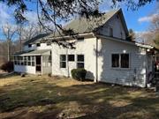 This Colonial/Cape home, gracefully nestled on an acre of land right in New City. In addition to its natural beauty, it boasts extra bonus rooms for play, relaxation and work. The bedroom areas on the second floor offers its own unique character. There are 3 full bathrooms, recently updated, washer/dryer area off kitchen. Updated kitchen with quartz countertops, two sinks, microwave, refrigerator and oven/stove. Enjoy the covered porch/sun room on any day! Home is being sold as-is.