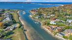 Seller is motivated and will listen to all reasonable offers!! Rare opportunity on the North Shore to have a house with a dock that can fit up to a 42-foot boat!! Seller has expedited permits from the town to add a bulkhead WATERFRONT living, with your own private BOAT SLIP and BEACH RIGHTS. Only 9 HOUSES are part of the Goose Landing Homeowners Association DEEP WATER DOCK only $500 a year. 3 FLOORS of multi-level decks and balconies solariums and panoramic WATER VIEWS House was brought down to the studs in 2018 RENOVATED by 2019 with all new ANDERSON double pane STORM WINDOWs and SLIDERS, insulation, doors, NEW vinyl siding for MAINTENANCE FREE living. All NEW KITCHEN and BATHROOMS, separate floor PRIMARY en SUTE with 2 dressing rooms SOAKING TUB, water closet and a wood burning FIREPLACE and sitting room. The new eat in Kitchen has Granite, brand-new stainless-steel appliances a large island, double ovens with convection. a microwave drawer, wine fridge plus a pantry and a separate laundry room. The lower level has a MEDIA THEATRE ROOM den, 2 bedrooms half bathroom office and a FIREPLACE with sliders out to the patio and the WATER with its own FISHING DOCK. The living room has vaulted ceilings an oversized stone FIREPLACE with sliders out to the deck with WATERVIEWS. WOOD FLOORS throughout, a COURTYARD and sliders off of one of the bedrooms. 9 Porpoise has a 2.5 CAR GARAGE with a pull-down stand-up attic with skylights that can be finished. The seller has paid and has plans and for the new bulkhead permits in place. This home is also part of the private WILLO BEACH ASSOCIATION. Porpoise court has a 3 FLOOR glass ELEVATOR. The perfect home for entertaining and VACATION LIVING year-round in the beautiful enclave of NORTHPORT VILLAGE close to all the shopping, theatre. dining and cafes. The INLET is perfect for DEEP WATER BOAT DOCKING, KAYAKING and enjoying the SUNSET from one of the multi deck balconies overlooking the HARBOR., Additional information: Appearance:Diamond+++, Green Features:Insulated Doors, Interior Features:Guest Quarters, Lr/Dr, Marble Bath, Separate Hotwater Heater:Y Custom window treatments , motorized shaded in primary suite.