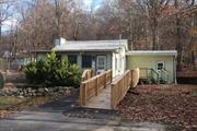 this charming 2 bedroom 1, 040 sq. ft. private cottage on 1/2 an acre, is it! This picturesque home boasts cozy country kitchen w/a retro vibe, spacious living room adorned with a decorative fireplace, and beamed cathedral ceiling welcomes you home. Modernized bathroom, featuring a walk-in shower, adds to your comfort. Newly added wood deck with ramp completes the picture. Lots of land for the gardening enthusiast. One of the standout features of this cottage is the inclusion of multiple ceiling fans. They not only enhance the aesthetics of the home but also ensure that fresh air circulates effectively, keeping you comfortable throughout the seasons.