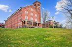 Welcome home to this stunning top floor corner unit located in the historic School House Loftsat Chapel Hill. Situated on 100 acres of manicured grounds, this duplex unit offers historiccharm with modern amenities. Step inside and be welcomed by an open floor plan highlightedby 14-foot ceilings, exposed brick and large arched windows for stunning westerly sunsets. Thegut-renovated unit features COREtec flooring throughout, grey shaker cabinetry in the kitchenwith white Cambria quartz countertops, metal linear mosaic backsplash, stainless-steelappliances and an electric built-in fireplace. Upstairs youâ€™ll find two en-suite bedrooms withvaulted ceilings, skylights and large arched windows. The primary suite features a beautifullyrenovated bath with heated floors. Additional bedroom suite features a step-in shower and aroomy walk-walk in closet. Entire Loft has custom window treatments, brand new HVACsystem, Google Nest Thermostats, powder room, laundry closet, a one-car garage with astorage loft and a separate storage unit. The amenities include a walking trail, playground, bocce courts, pickleball, tennis and an outdoor pool. The lifestyle center features a gym, exercise classes, sauna, basketball and a busy activity calendar. Close to Peekskill Metro-Northtrain station, parks, Blue Mountain Reserve, breathtaking waterfront, and restaurants. Come seefor yourself why so many people want to call Chapel Hill home!