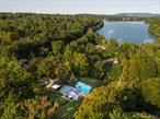 Rare opportunity to purchase this breath taking one of a kind estate in Monroe that consists of three homes nestled on 3.5 stately landscaped acres affording you peace and privacy!  Surrounded by the original stone walls of this compound, this unique oasis offers a huge 50, 000-gallon gunite in-ground pool with Italian glass tile, patios overlooking the gorgeous park-like grounds, and a new tennis/pickleball/basketball sports court. The 1st/main residence unfortunately had fire damage and will need to be renovated/rebuilt.  The owner was going to rebuild but never got to it. The 2nd residence called the â€œstone cottageâ€ has 2 fieldstone fireplaces, a full kitchen, a vaulted ceiling in the bedroom, a washer/dryer, and a full bath. The 3rd residence is called the â€œwhite cottageâ€ and sits atop the highest point on the property. This charming cottage has 2/3 bedrooms, a large kitchen, a full bath, and a new 400 sq ft Trex deck with custom railings that is totally private to enjoy the 3.5 acres of trees and woods. Perfect opportunity to keep family close or rent out the additional homes and have the property pay for itself.  The property has all this to offer, lake rights and it is located in the sought after Village of Monroe near Mill Pond with Monroe-Woodbury Schools. Great location, close to restaurants, quaint boutiques, farmers markets, wineries, shopping, state parks, 50 miles to NYC, near 84, 87, 17, Metro North/ NJ Transit & buses to NYC, Stewart & West Point. Schedule to see it now, this one will not last.