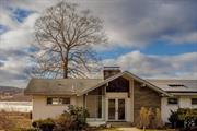 Set on an acre in historic Hyde Park, this mid-century modern home offers timeless design, modern updates, and spectacular natural surroundings. Built in 1960, it boasts expansive Hudson River views and the tranquil sight and sound of a picturesque waterfall visible from the front of the property. The upper level features a sleek renovated kitchen with ample counter space and natural light, opening into a large dining and living area with high ceilings, built-ins, and a wood-burning fireplace. Glass doors lead to a wide deck overlooking the Hudson River, perfect for indoor-outdoor living. The main level also includes the primary bedroom with river views and an en-suite bathroom, plus two additional bedrooms and a shared hall bath. Downstairs, the lower level offers a versatile den or office, a spacious living area with a built-in bar, a second fireplace, and a walk-out terrace to the backyard. A third bathroom, laundry room, storage, and two-car garage with an additional carport complete this level. All three bathrooms in the home feature original fixtures and design elements that are a true testament to the home&rsquo;s mid-century origins, while solar panels and two Tesla batteries are some of the many modern amenities this home features. Hyde Park itself is steeped in history, home to the Franklin D. Roosevelt Presidential Library, Vanderbilt Mansion, and the Culinary Institute of America, while Rhinebeck is a ten minute drive with its boutique shops and fine dining. For commuters or weekenders, NYC is less than two hours away, with both Amtrak and Metro-North stations just 15 minutes from your door.