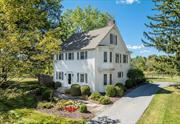 This circa 1910, handsome Hudson Valley farmhouse on 19+ acres is a wonderful country retreat, perfect for entertaining family and friends. It boasts beautiful wood flooring, attractive high ceilings, and ample windows that provide an abundance of natural light and take full advantage of picturesque views of the outdoors. A fireplace adds winter warmth and the central air adds summer comfort. The first floor includes a lovely foyer, a formal dining room, a kitchen, a cozy family room with a glass door to a covered side porch, a sunlit den, a mudroom and a powder room. A primary suite and three additional bedrooms, a full bath and a laundry area make up the second floor. The third floor adds a fabulous bonus room with a vaulted ceiling. The grounds are beautiful, featuring a mix of meadow and woodlands, finely fenced pastures, a sand riding ring, and a large pond. There is a detached garage and a four stall barn, with a tack room and storage room, that is well-situated on the property. The land offers a wonderful natural setting where one can connect with nature, enjoy outdoor recreation or simply relax on the spacious flagstone patio to enjoy wildlife and the pastoral views. A charming home in a pleasing setting, this is the ideal place to escape to on weekends, or live in year-round. A short drive to the Village of Millbrook and the Metro North train station. 90 minutes to NYC.  Dutchess County offers something for everyone: parks, shopping, great restaurants, hiking, horseback riding, antiques shops, wineries, farmers markets or just relax and enjoy true tranquility.