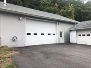 Spacious heated garage at 249 Route 210, Stony Point, NY with a ceiling height of 13â€™ 9â€. Features an 18â€™ wide by 12â€™ high garage door and a large mezzanine for additional storage (not included in square footage). Ideal for contractors, storage, or a versatile workspace. Donâ€™t miss this functional and well-equipped space!