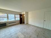 Spacious 2 Bedroom Apartment in Woodhaven Near J Train, Supermarket, Public Transportation Featuring Hardwood Floors, Closet Space, Formal Dining Room, and Living Room.