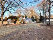 Ranch-style home featuring four bedrooms, two bathrooms, a kitchen, living room, and dining room with a fireplace. Situated on just over half an acre, this property offers plenty of potential.