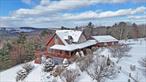 Could you live with stunning views of the Delaware River valley and the surrounding Catskills? Watch bald eagles and hawks glide past your windows? This Beechwoods contemporary is set in a hilltop neighborhood of upscale homes. Elegant Douglas Fir post-and-beam framing creates a high cathedral ceiling and open space. All rooms have soaring views of sky, mountains and the river. South and west siting provides all-day sun. Solar roof panels, low-E Andersen windows, and 4-zone radiant heat make for an energy-efficient home. Air conditioning is handled by a 2-zone ultra-quiet Fujitsu central system plus 4 Fujitsu ultra-quiet mini-split units, making a total ofÂ 6 AC zones. 5G cell service and Spectrum fiber-optic 1GB internet keep you connected, and a whole-house generator keeps you up and running. A wraparound deck, covered front porch, stone patio, and firepit provide easy outdoor spaces for relaxing, entertaining, and enjoying the view. With 4, 682 square feet, 5 BRs, 3 full baths (new fixtures) and spacious rooms, you&rsquo;ll handle a crowd. Kitchen has granite counters and new/recent Bosch and Samsung appliances. Wine cooler and extra fridge in pantry. New washer & dryer. Family room has a pool table, propane fireplace, built-in surround sound, and a home theater. Fully equipped gym also has a sauna. The 6-car garage is insulated, heated, and houses a Tesla EV charger. All mechanicals are high-end and were installed 2018-2019. A new roof was installed in 2019. A large, side-attached garden equipment storage room provides exterior access to garden tools and equipment. The grounds are both landscaped and wild, with multiple outdoor walking and gathering spots. Mature plantings, a pond, and a hiking trail enhance the natural beauty of this special Catskills retreat. Just 2 hours from NYC; 5 minutes from Callicoon and the Delaware River.